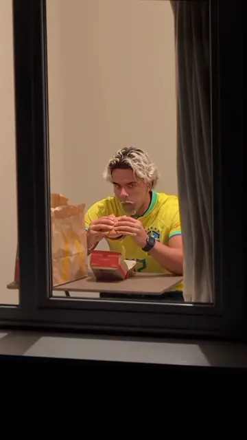 Yellow football shirt, red burger box, the long stare